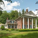 Front Exterior showing large main yard, columned front porch and side porch for Helen's Room